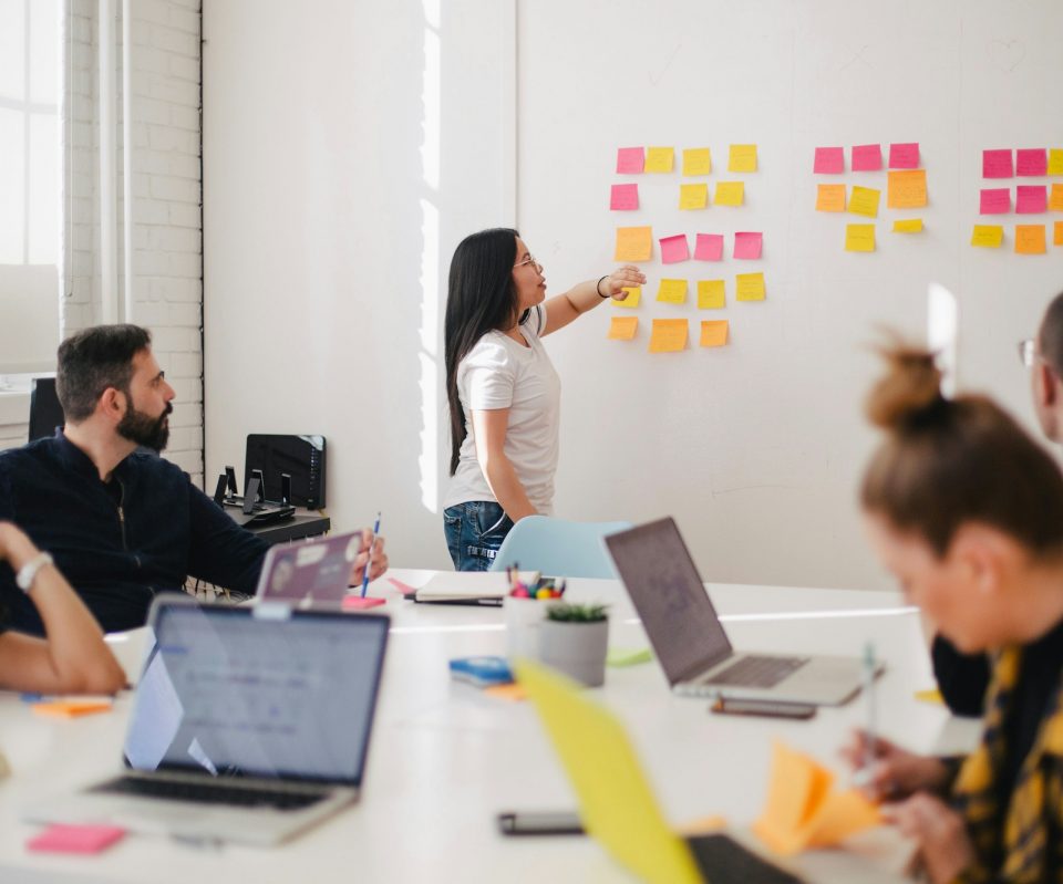 woman placing sticky notes on wall